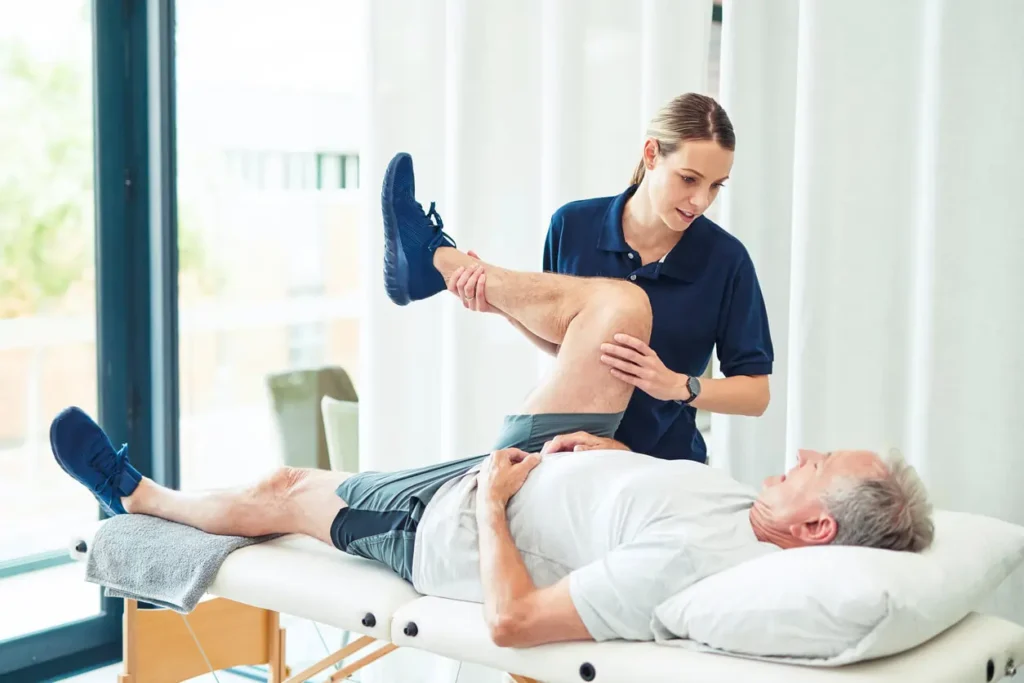 Revitalising Recovery: Effective Rehabilitation Strategies for Muscle Injuries 3 Physiotherapist assisting a patient with muscle recovery exercises Cranleigh
