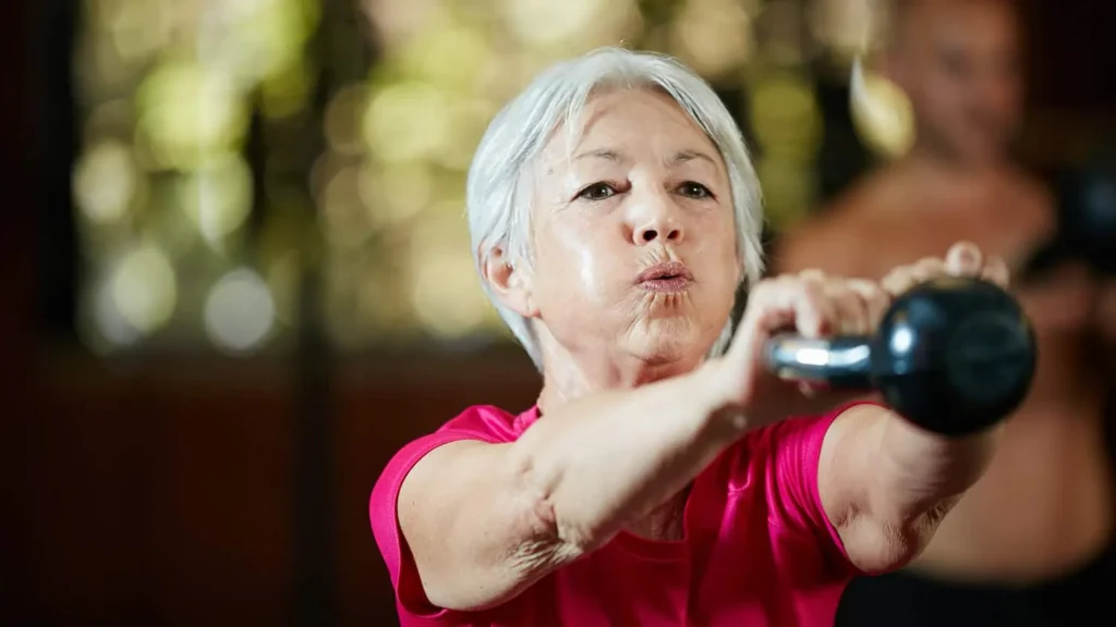 Toning Bingo Wings: Effective Exercises and Tips for Achieving Sleeker Arms 2 Person performing arm exercises with dumbbells Cranleigh