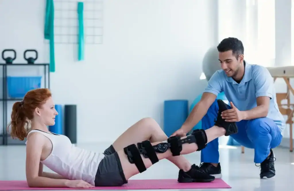 Woman having treatment to help muscle recovery Cranleigh after an injury