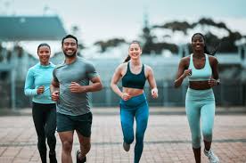 Sculpting Sleek Arms: The Essential Role of Cardio in Toning Without Bulking Up 3 image of people running to incorporate cardio Cranleigh exercise into their life to help tone arms and body.